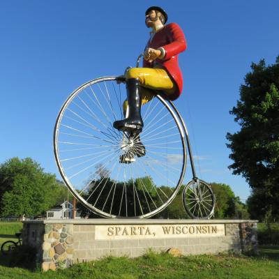 statue of a man riding an old bicycle